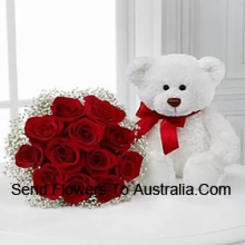 Bouquet de 11 roses rouges avec des remplissages saisonniers accompagné d'un mignon ours en peluche blanc de 14 pouces de hauteur