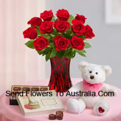 11 Red Roses With Some Ferns In A Glass Vase, A Cute 12 Inches Tall White Teddy Bear And An Imported Box Of Chocolates