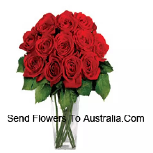 15 Red Roses With Some Ferns In A Glass Vase