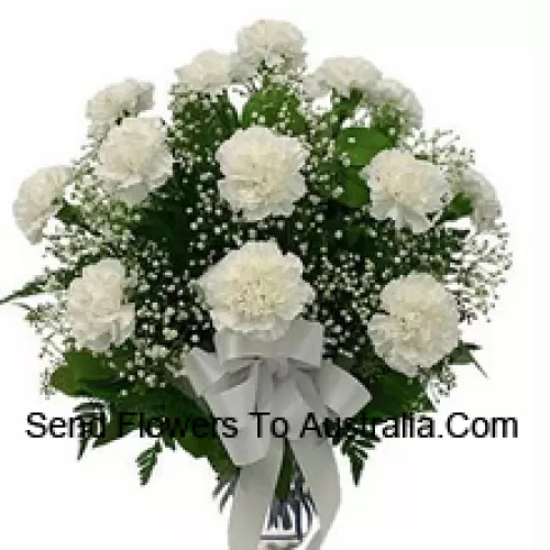 19 White Carnations With Seasonal Fillers In A Glass Vase