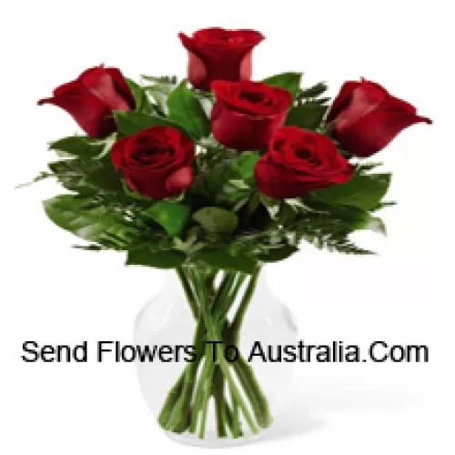 7 Red Roses With Some Ferns In A Glass Vase