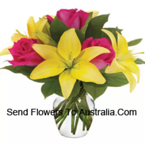 Pink Roses And Yellow Lilies With Seasonal Fillers Arranged Beautifully In A Glass Vase