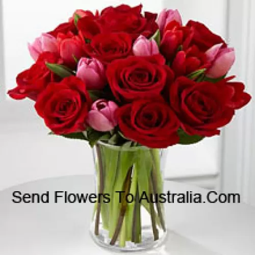 11 Red Roses And 6 Pink Tulips With Some Seasonal Fillers In A Glass Vase