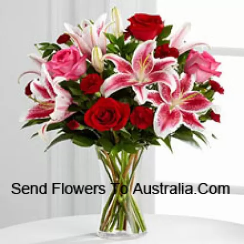 Red And Pink Roses With Pink Lilies And Seasonal Fillers In A Glass Vase